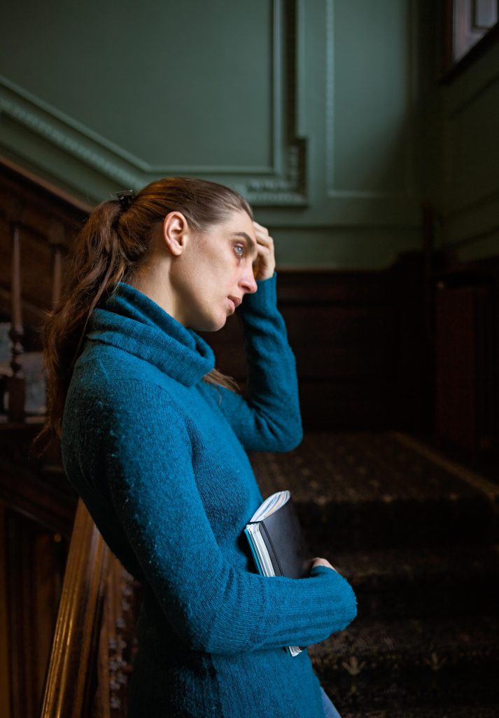 Margje Bijl standing on the staircase of the William Morris Gallery, looking out the window, thinking of Jane Morris