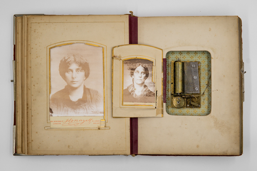 antique photo album with two women