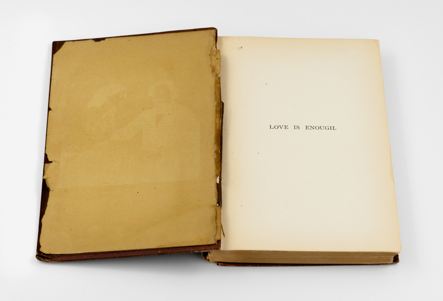 vague image of couple, Jane and William Morris, on an antique book page.